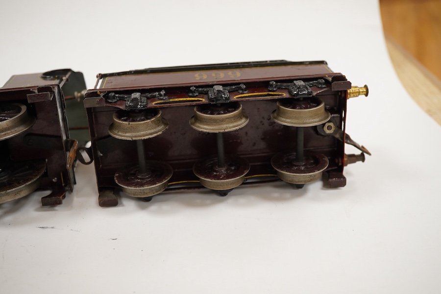 An 0 gauge Bing clockwork tinplate Midland Railway 4-4-0 tender locomotive, 999, in maroon livery with yellow and black lining and original clockwork mechanism